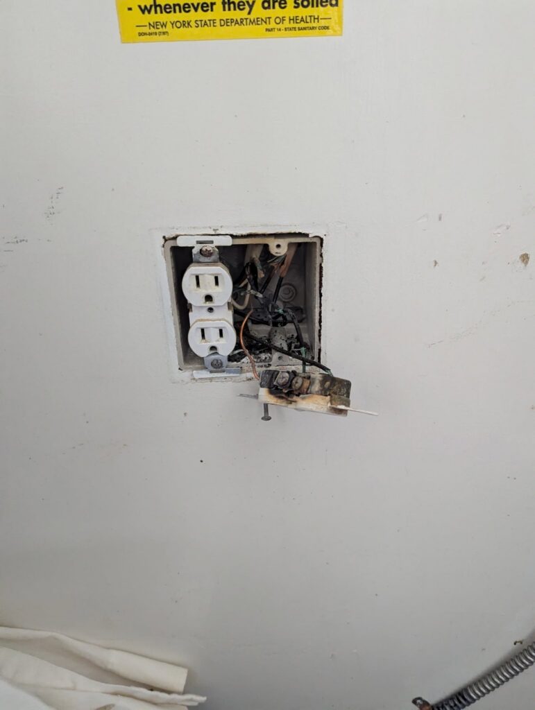 Burnt electrical receptacle, a fire hazard found by Colonial Electric in an Albany NY home